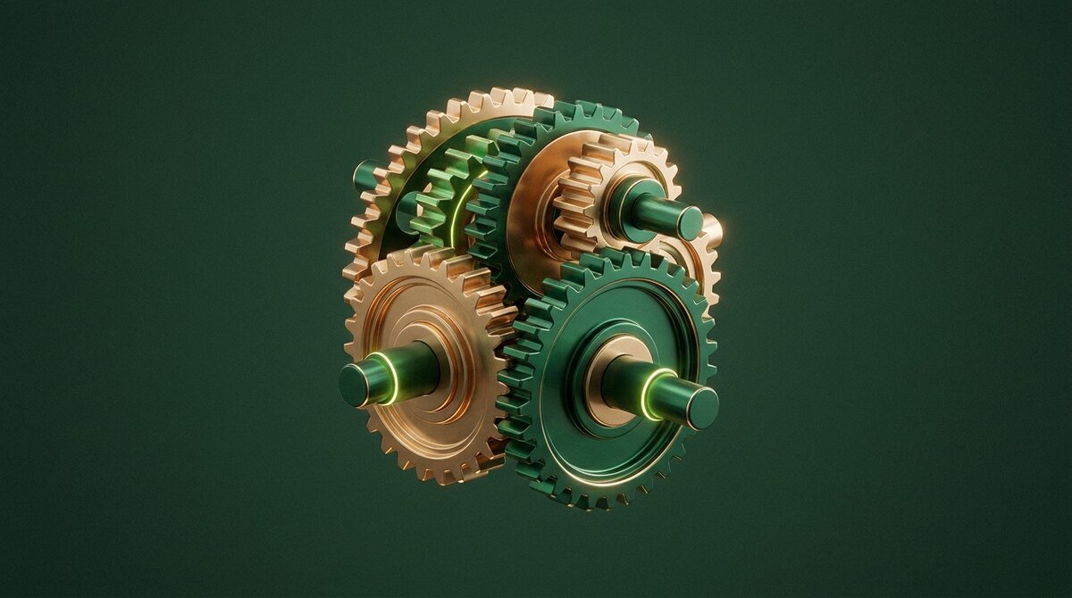 Polished brass and emerald gears meshing and turning together as one self-running mechanism